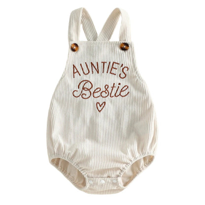 Full front view of a unisex baby beige corduroy bubble romper featuring brown "Auntie's Bestie" embroidery and faux tortoiseshell buttons on the straps.