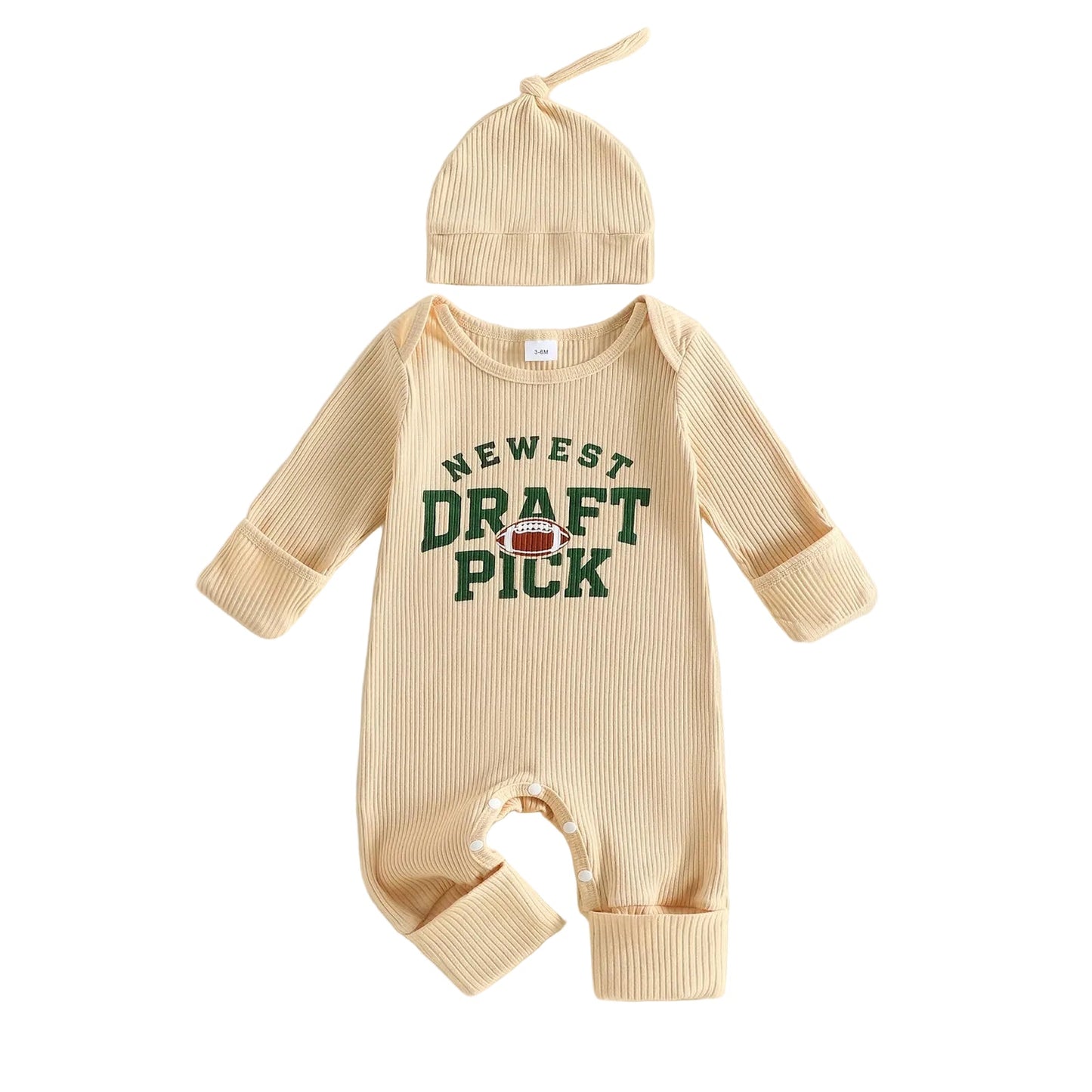 Flat lay front view of a beige unisex baby long-sleeve ribbed romper featuring a "Newest Draft Pick" football graphic, paired with a matching knot hat.