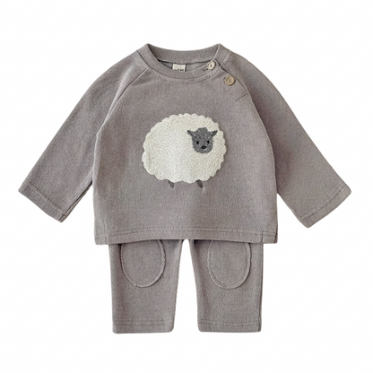 Flat lay of a grey unisex baby and toddler knit 2-piece set featuring a pullover sheep sweater and matching pants with knee pads on a white background.