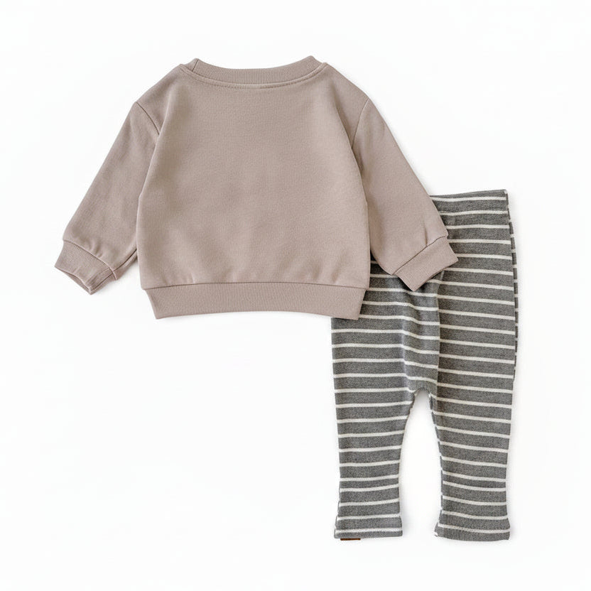 Back view of the gender-neutral baby 2-piece outfit showing the plain beige long-sleeve top and grey striped pants laid flat.