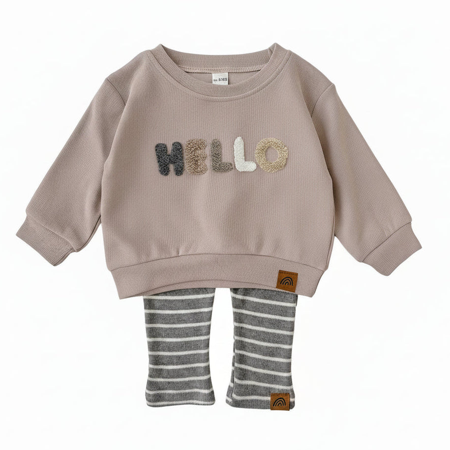 Front view of a gender-neutral baby 2-piece outfit featuring a beige long-sleeve top with textured HELLO embroidery and grey striped pants laid flat on a white background.