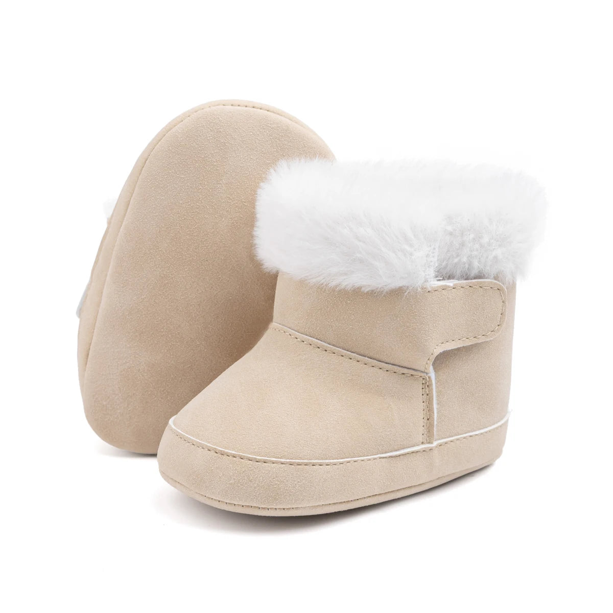 Pair of beige unisex baby soft sole crib boots with plush white lining on a white background.