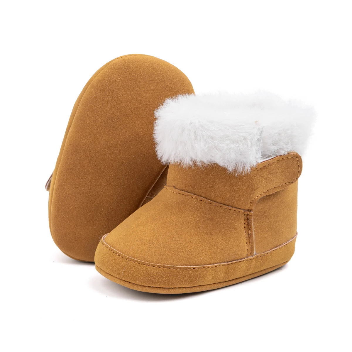 Pair of brown unisex baby soft sole crib boots with plush white lining on a white background.
