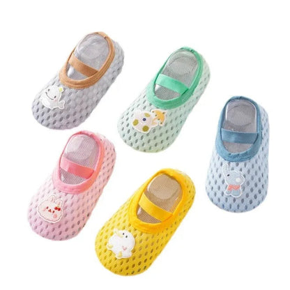 A group of unisex baby and toddler water shoes in various colors including mint green, yellow, pink, and blue, featuring whimsical teapot and animal patches with non-slip rubber soles.