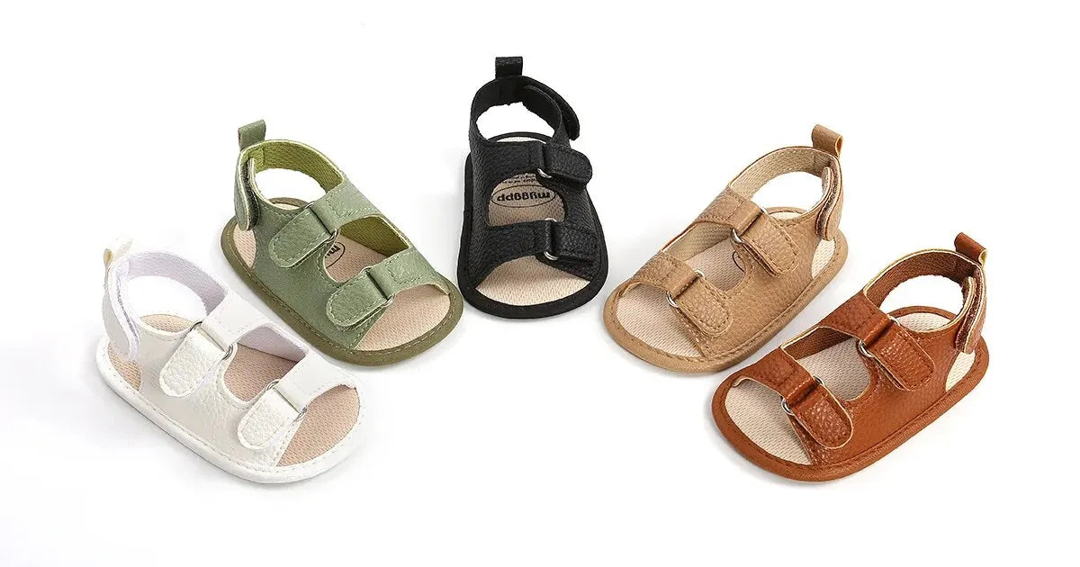 Collection of unisex baby summer sandals in five colors: white, sage green, tan, brown, and black, made from premium vegan leather with anti-slip rubber soles.