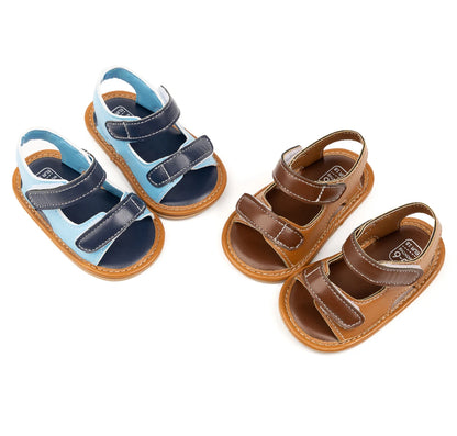 Pair of light blue and brown vegan leather baby boy summer sandals on a white background.