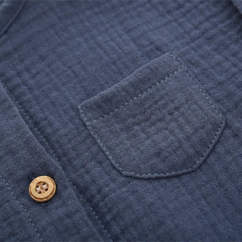 Close-up detail of the mini chest pocket on the navy blue vintage-inspired infant jumpsuit.