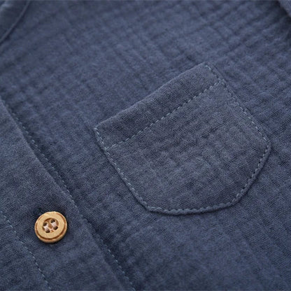 Close-up detail of the mini chest pocket on the navy blue vintage-inspired infant jumpsuit.