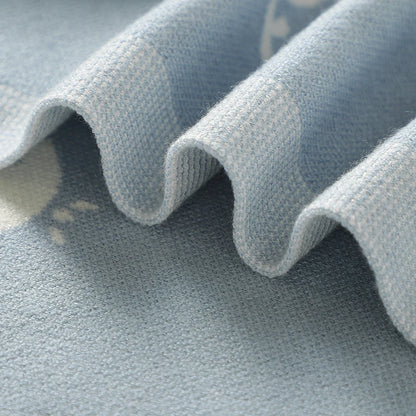 Close-up of soft, wavy folds in the viscose knit baby blanket demonstrating lightweight texture