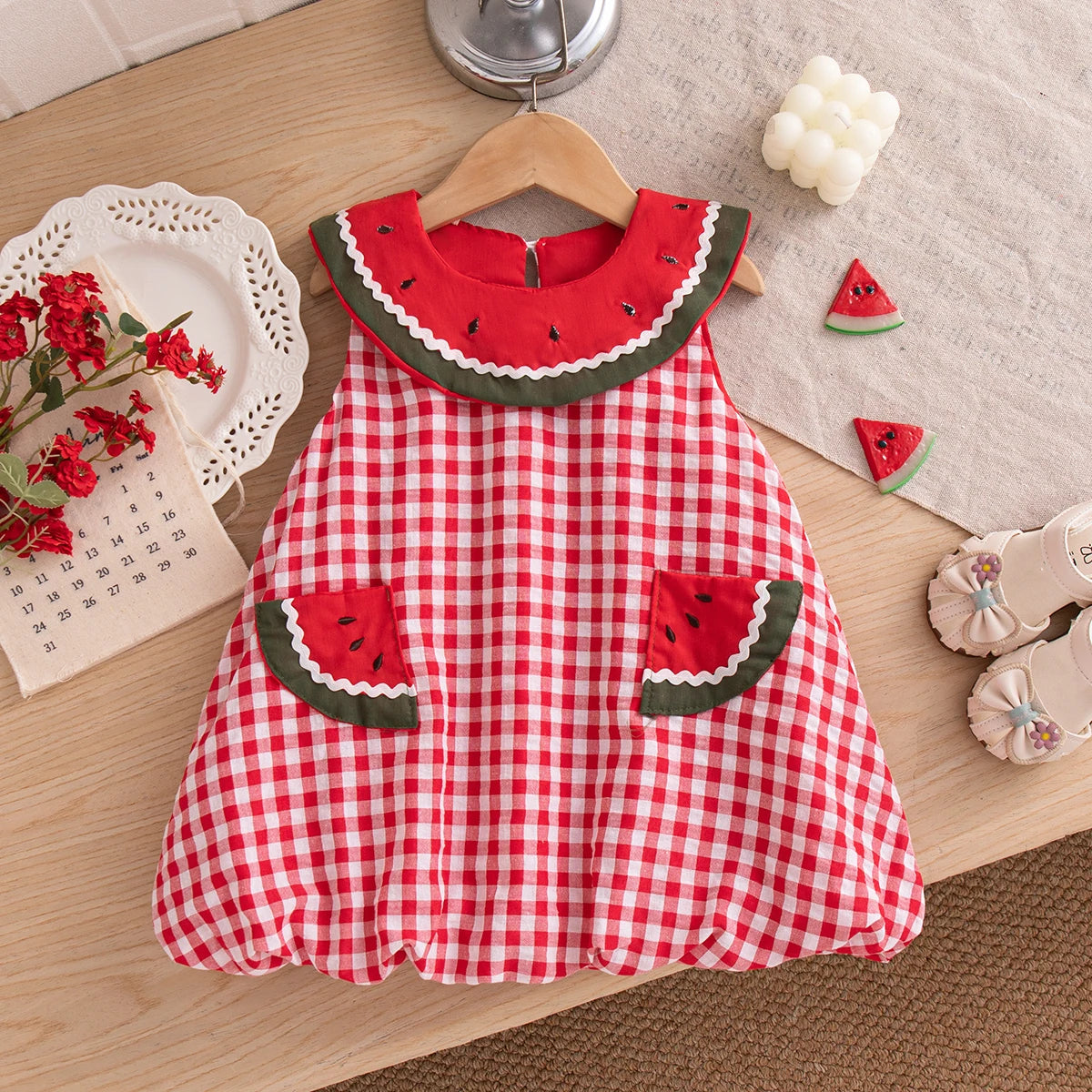 Front and back view of the Watermelon Red gingham bubble dress for toddlers featuring a large white scalloped collar with watermelon seed details.