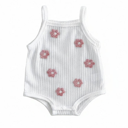 White ribbed sleeveless baby girl romper featuring pink 3D floral towel embroidery on a clean white background.
