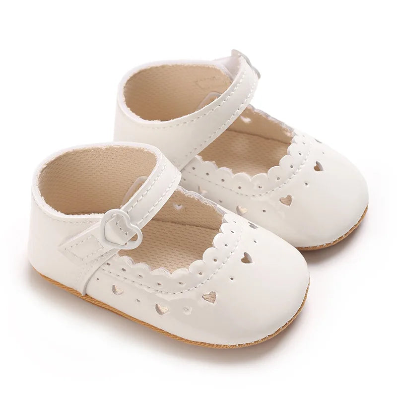 White vegan leather Mary Jane dress shoes for infant and toddler girls.