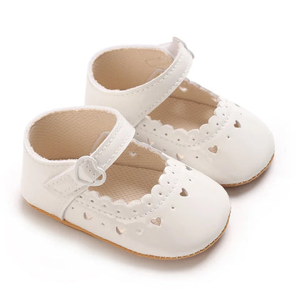 White vegan leather Mary Jane dress shoes for infant and toddler girls.