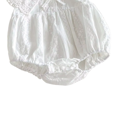 Lower body detail showing the gathered, puffy bubble silhouette of a white baby girl one-piece romper.