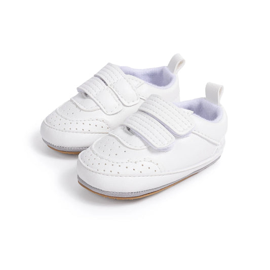 Pair of white classic infant sneakers with double adjustable straps and perforated toe details.