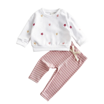 Baby girl's white long-sleeve pullover sweatshirt with colorful floral embroidery paired with pink and white striped leggings.