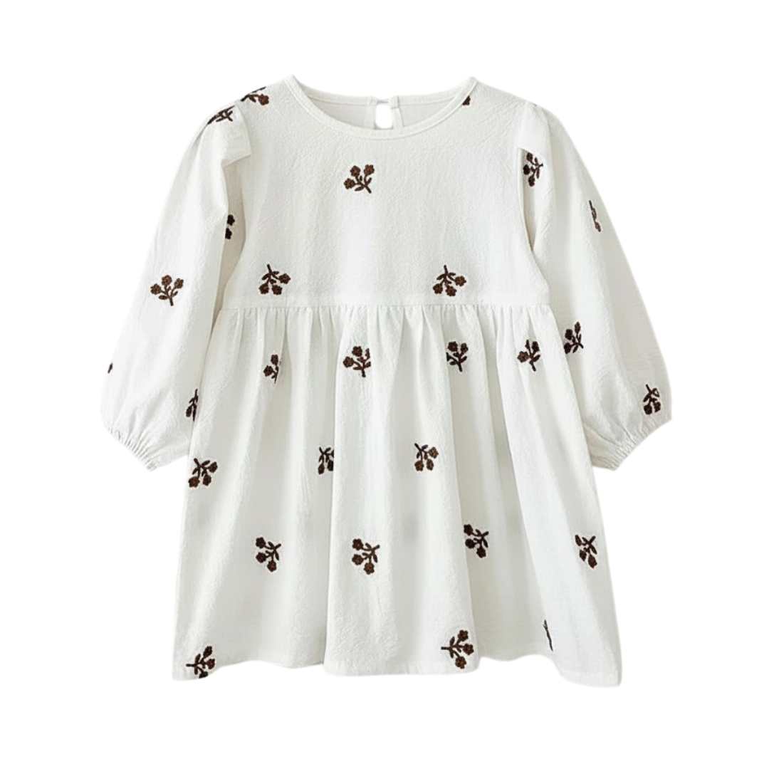 Flat lay of the crisp white long-sleeve cotton toddler dress featuring brown floral embroidery.