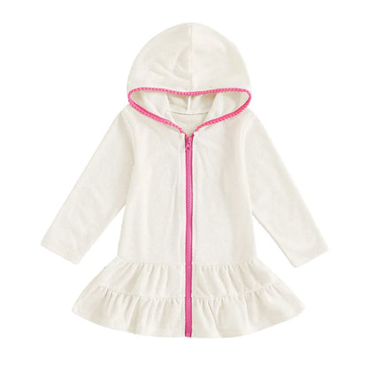 White long sleeve girls' hooded beach towel dress featuring a contrasting hot pink zipper and ruffle skirt.