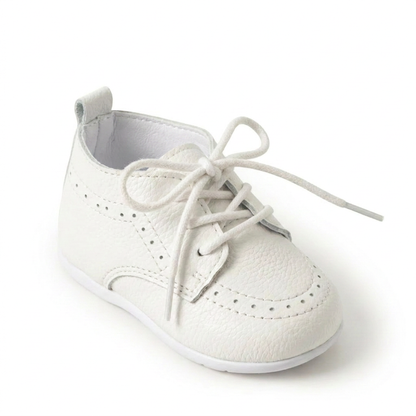 Close-up studio shot of a single Kidsely white pebbled faux leather lace-up formal oxford shoe for infants.