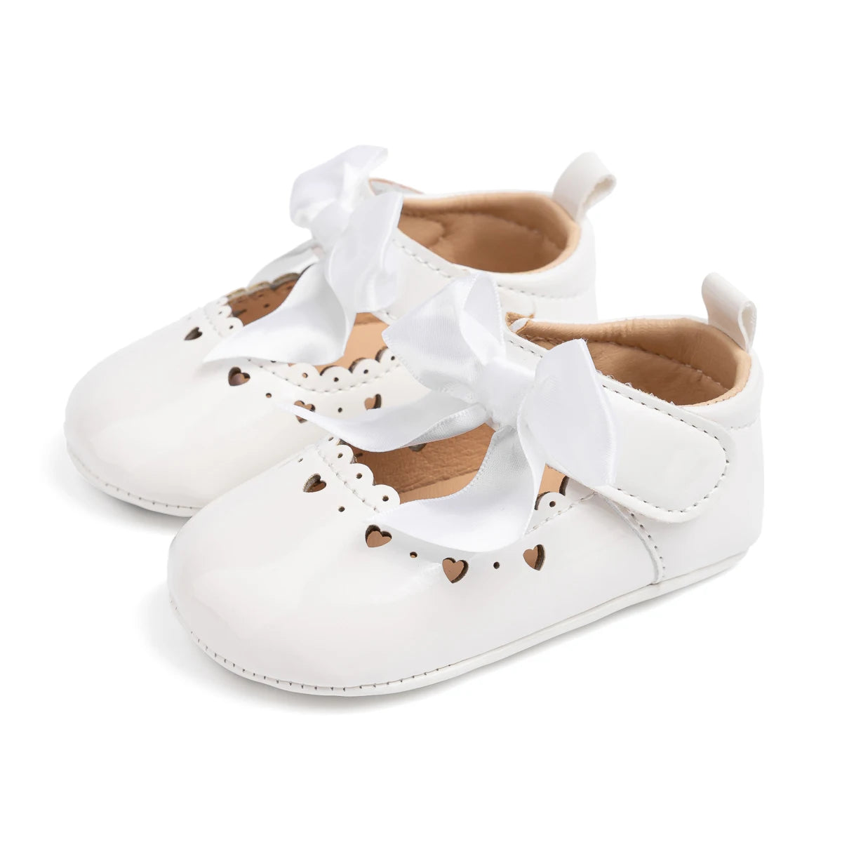 Pair of glossy white PU leather infant Mary Jane dress shoes featuring a prominent satin bow and scalloped trim.