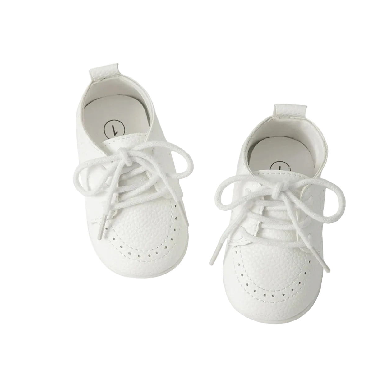 Overhead studio shot of a pair of Kidsely white textured pebbled faux leather baby brogue shoes with white laces.