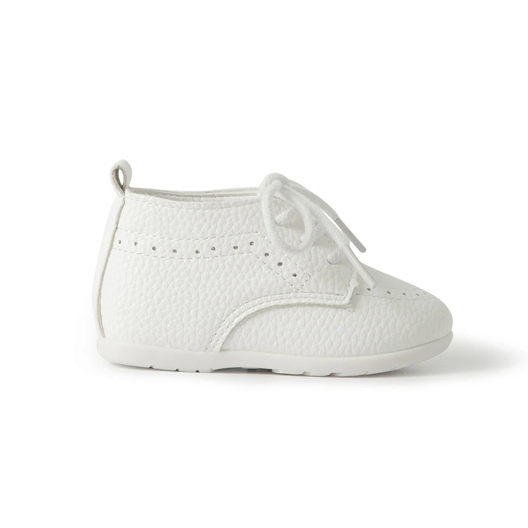 Side profile view of a Kidsely white pebbled faux leather infant dress shoe on a clean background.