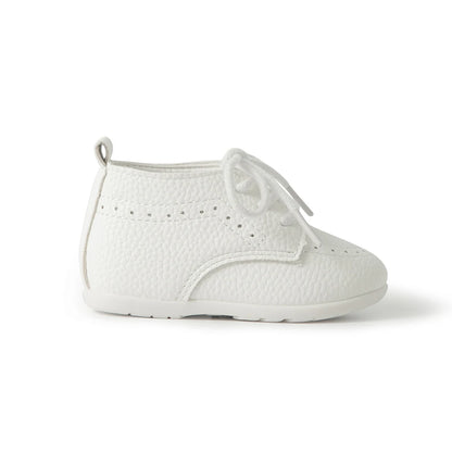 Side profile view of a Kidsely white pebbled faux leather infant dress shoe on a clean background.