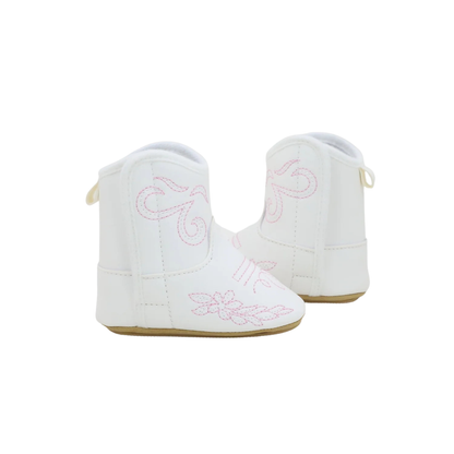Side profile of white baby cowgirl boots showcasing the detailed pink western embroidery.