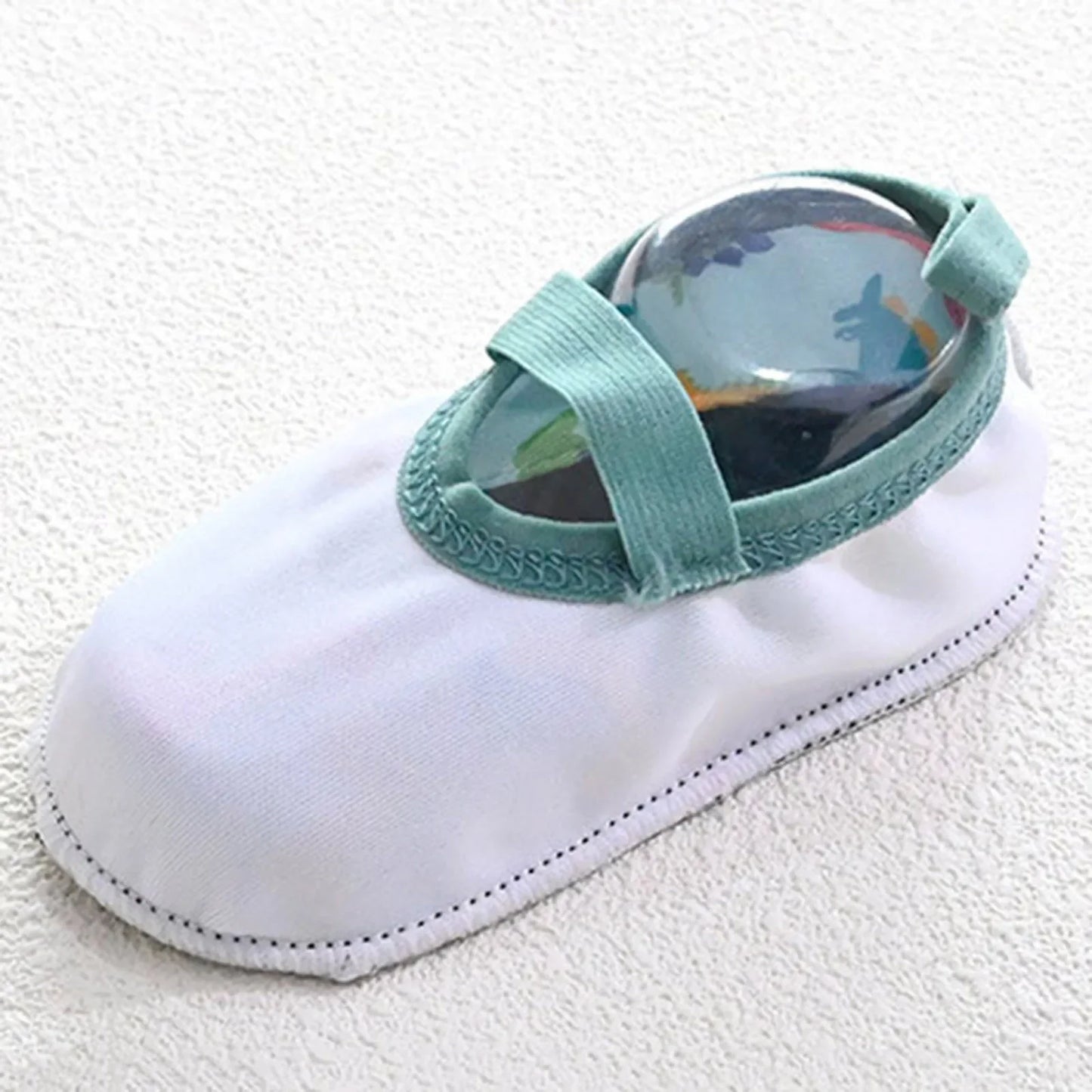 Close-up of a white sample shoe showcasing the stretchable, supportive elastic ankle strap designed to keep Kidsely shoes secure.
