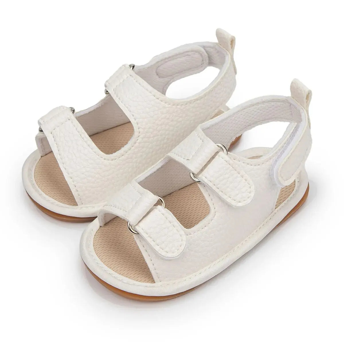 Pair of white vegan leather baby sandals for boys and girls featuring adjustable straps and a soft-grip rubber sole.