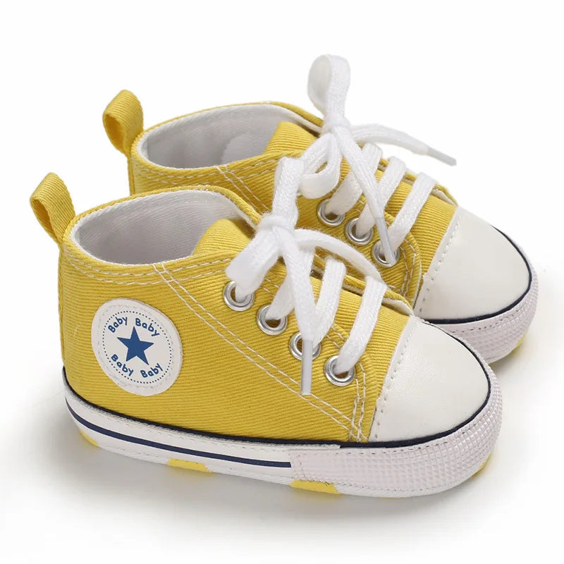 Vibrant yellow high-top canvas baby sneakers with classic white contrast stitching.