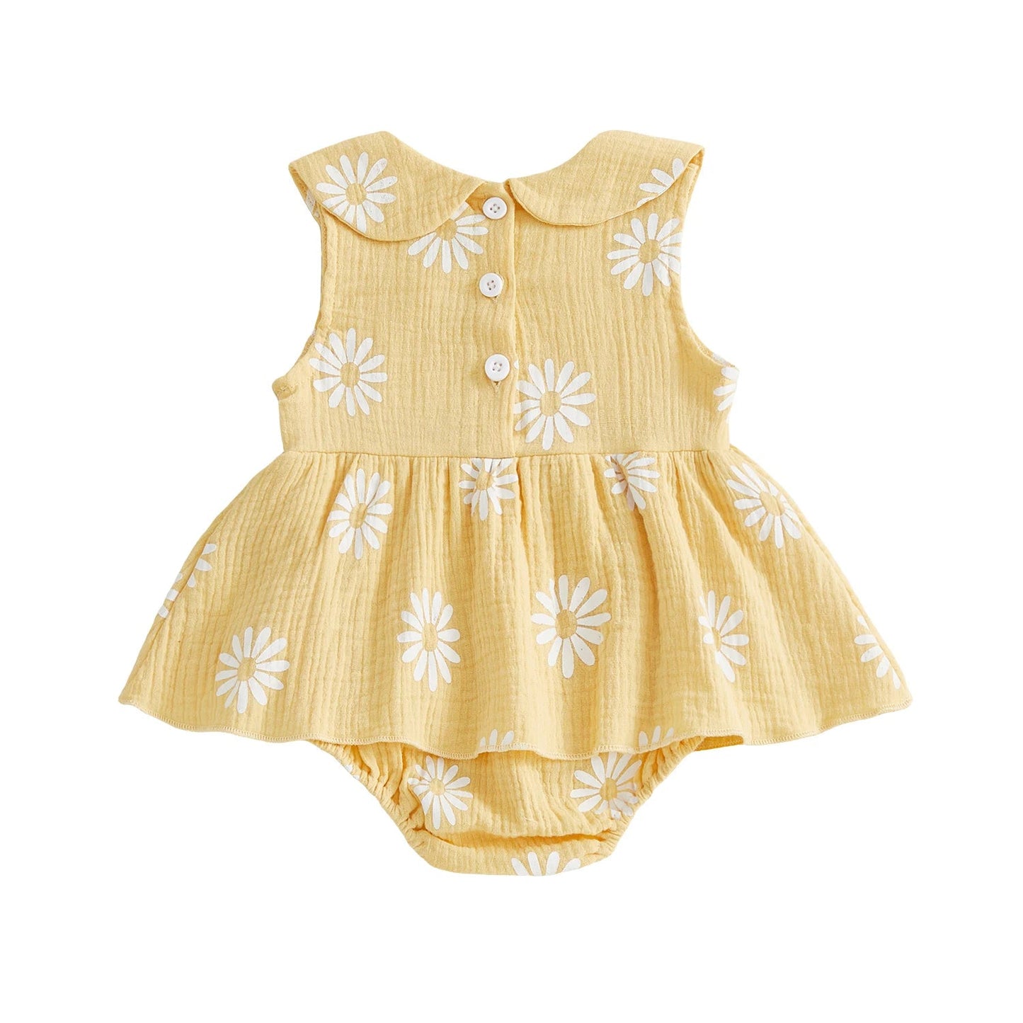 Back view of the yellow sleeveless baby girl daisy print romper dress showing the clean lines and ruffled skirt overlay.