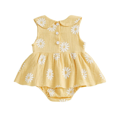 Back view of the yellow sleeveless baby girl daisy print romper dress showing the clean lines and ruffled skirt overlay.