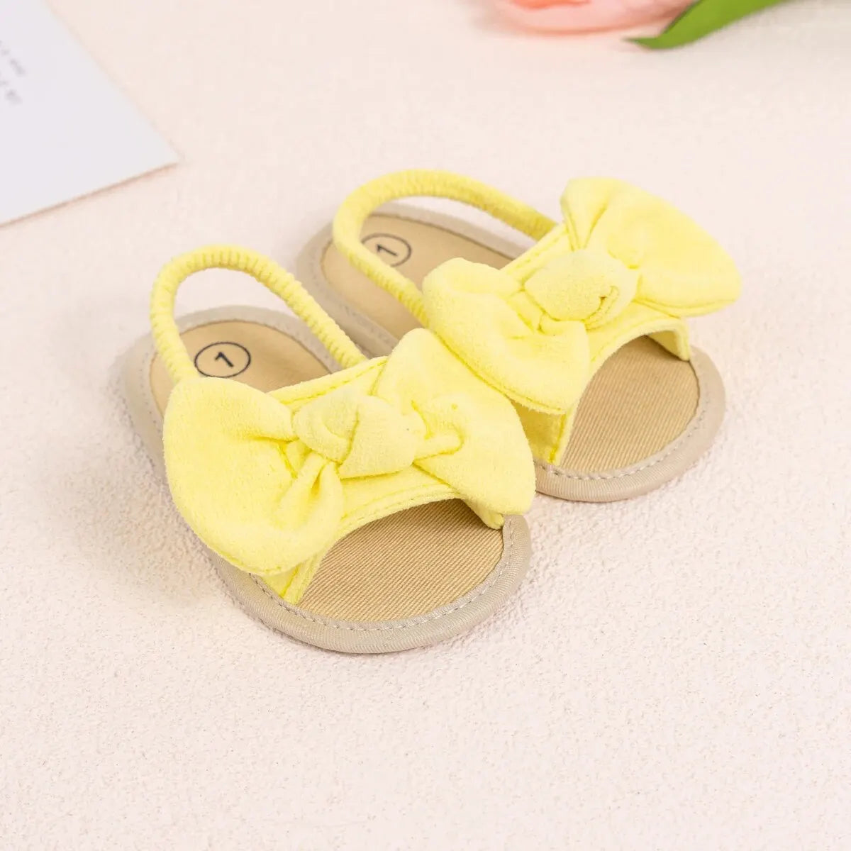 Top view of bright yellow infant summer sandals showing the wide toe box and soft brushed fabric material.