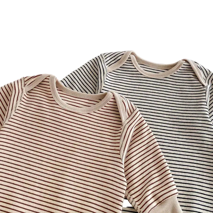 Close-up of the ribbed crew neckline on the neutral striped baby rompers in both Toasted Latte and Oat & Onyx colors.