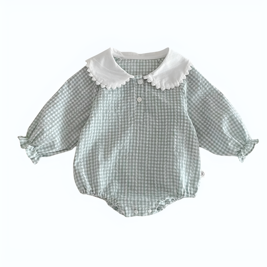 Flat lay of an elegant sky blue and white gingham baby girl romper featuring a white Peter Pan collar, long sleeves with ruffled cuffs, and front button details