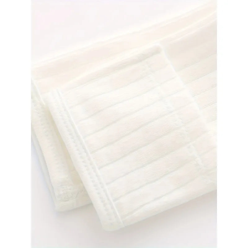 Close up of ribbed cotton fabric texture and soft folded cuff stitching on newborn long sleeve kimono top.