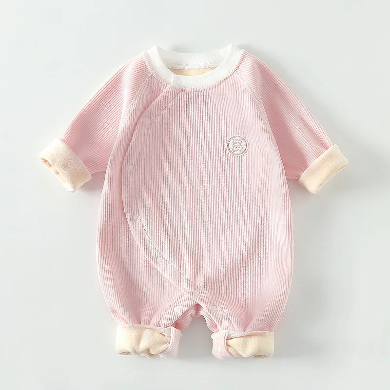 Soft pink ribbed cotton baby romper with kimono style side snaps and warm folded cuffs.