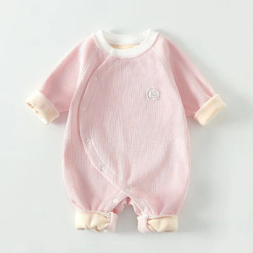 Soft pink ribbed cotton baby romper with kimono style side snaps and warm folded cuffs.