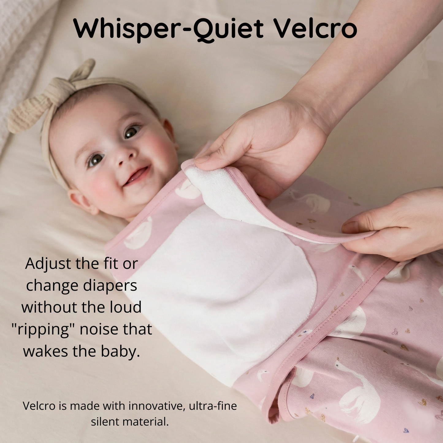 Close-up demonstrating the whisper-quiet silent velcro on the pink swan swaddle, made with ultra-fine material that allows for noise-free adjustments without waking the baby.