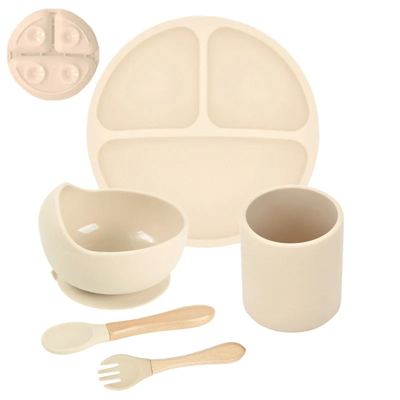 Beige children's dining set with plate, bowl, cup, spoon, and fork on a white background.