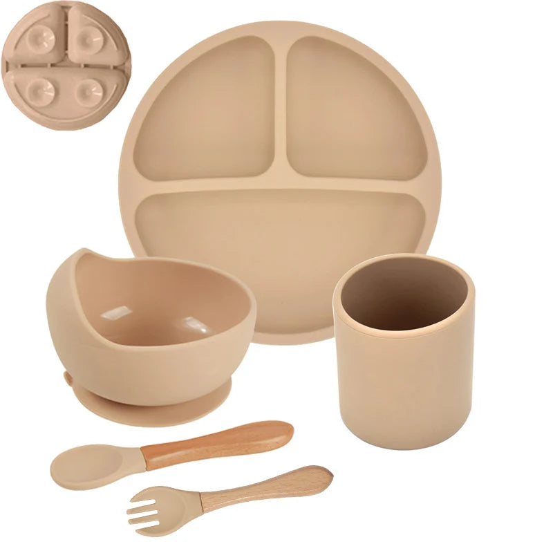 Khaki children's dinner set with plate, bowl, cup, spoon, and fork on a white background