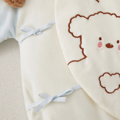 Detail view of kimono side-tie ribbons  on polyester baby romper.