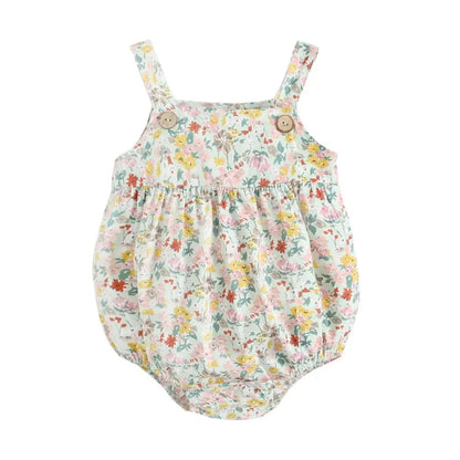 Flat lay view of a sage green floral cotton baby romper with sleeveless boho straps and vintage wood buttons.