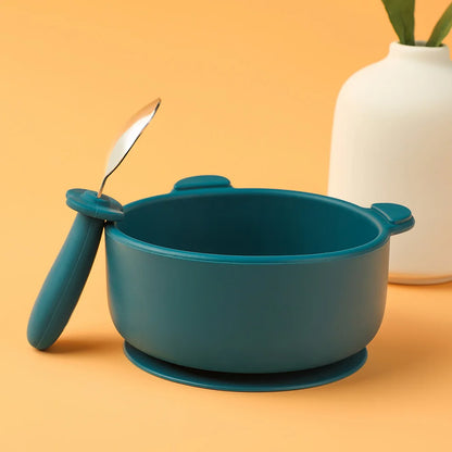 Blue bowl with handles and a spoon on an orange background