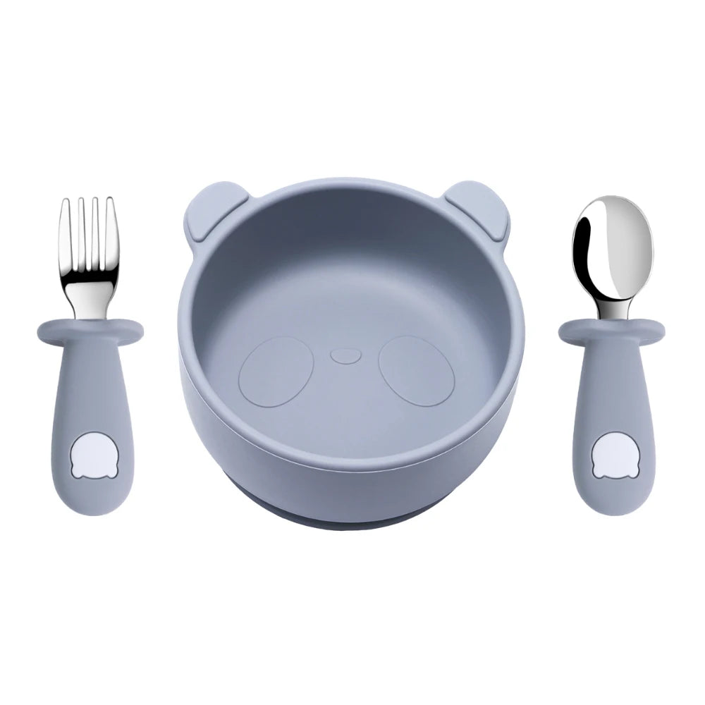 Children's dining set with bowl, spoon, and fork on a white background