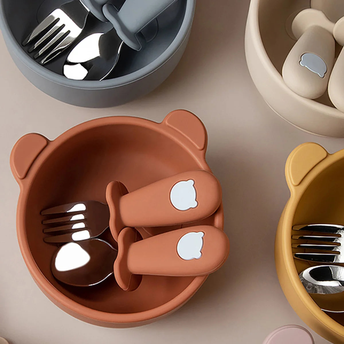 3-piece baby feeding set featuring a bear-shaped round suction bowl, silicone spoon, and fork.