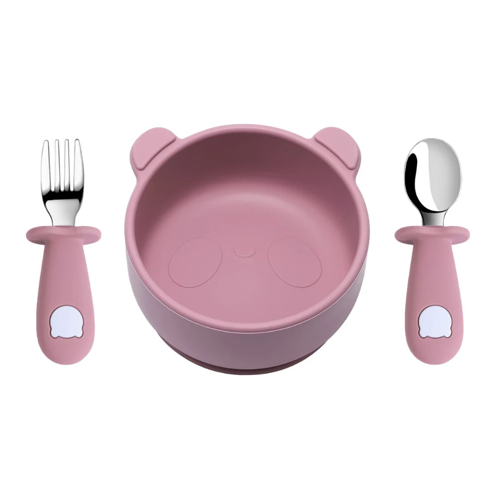 Pink children's bowl with bear ears, fork, and spoon on a white background