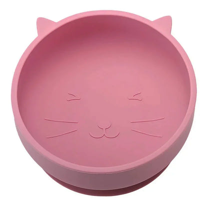 Pink silicone bowl with cat face design on a white background