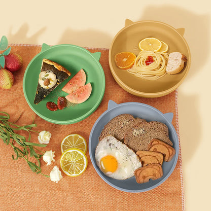 Three plates with breakfast food on a textured surface